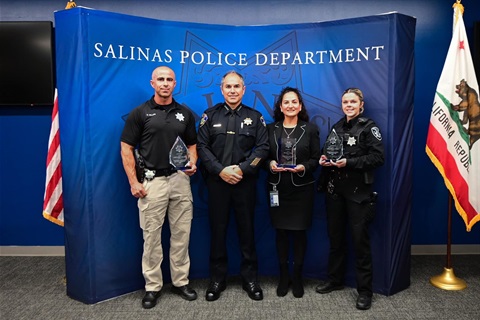1-male-2-female-awardees-holding-awards-standing-next-to-Police-Chief-in-front-of-blue-background