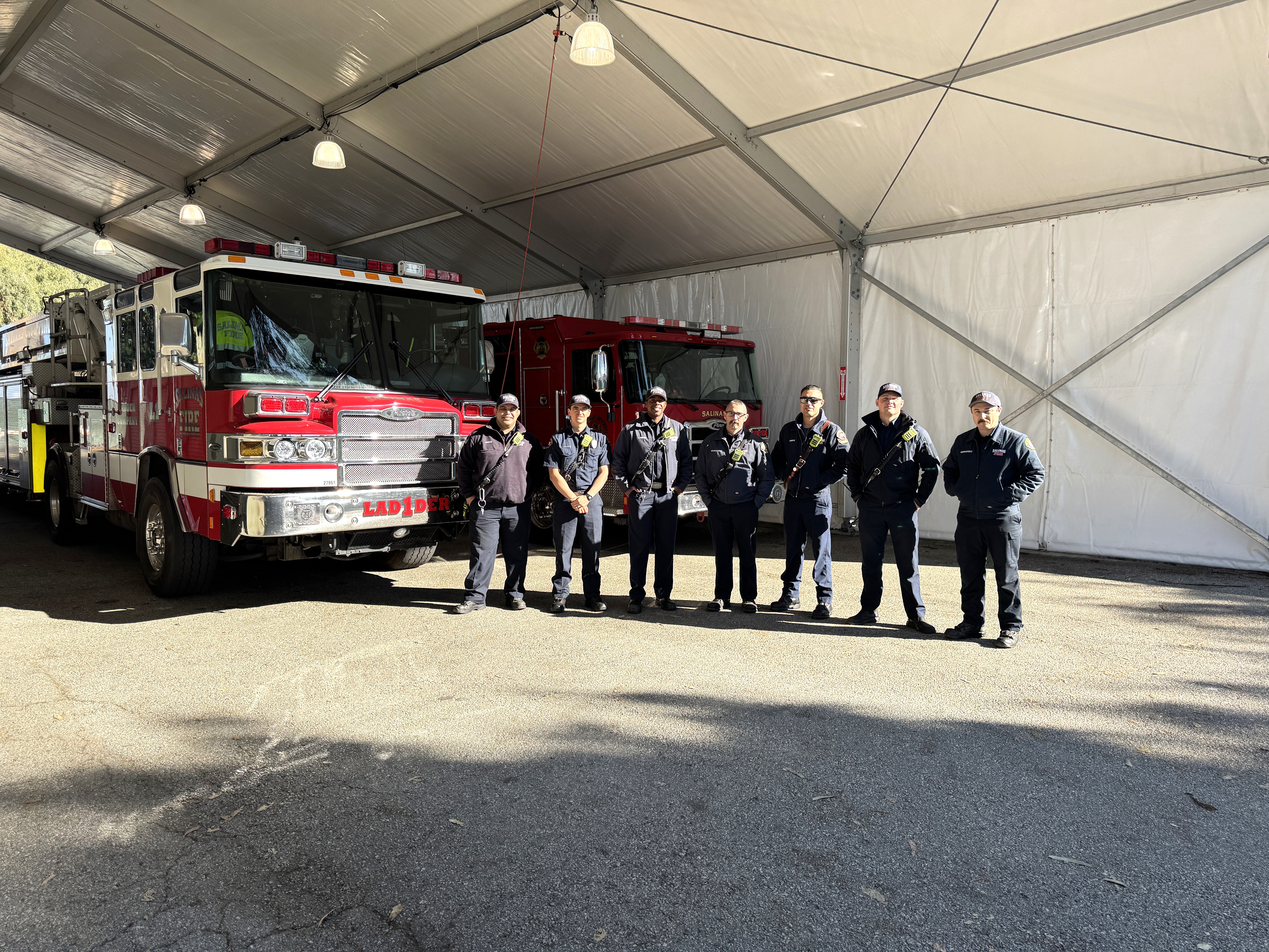 fire-personnel-standing-in-front-of-two-fire-trucks.JPG