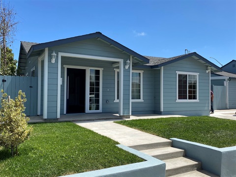 an approved ADU in Salinas, blue and matches house