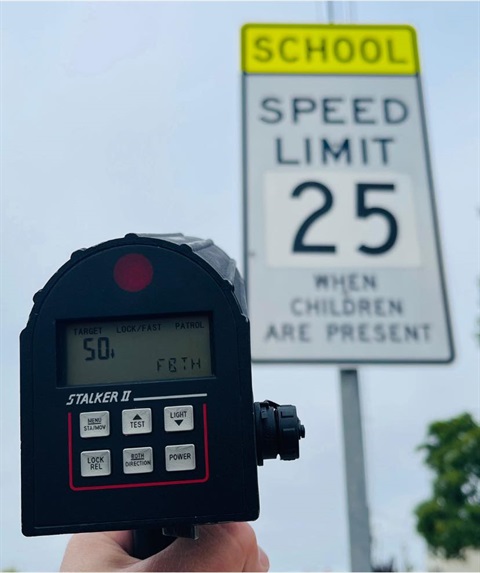 speed rader pointing at school zone sign